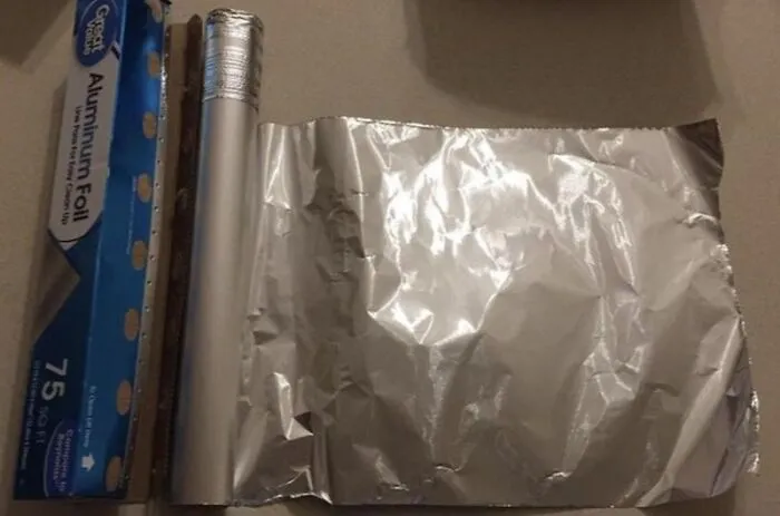 A poorly cut roll of aluminum foil, representing annoying roommate stories