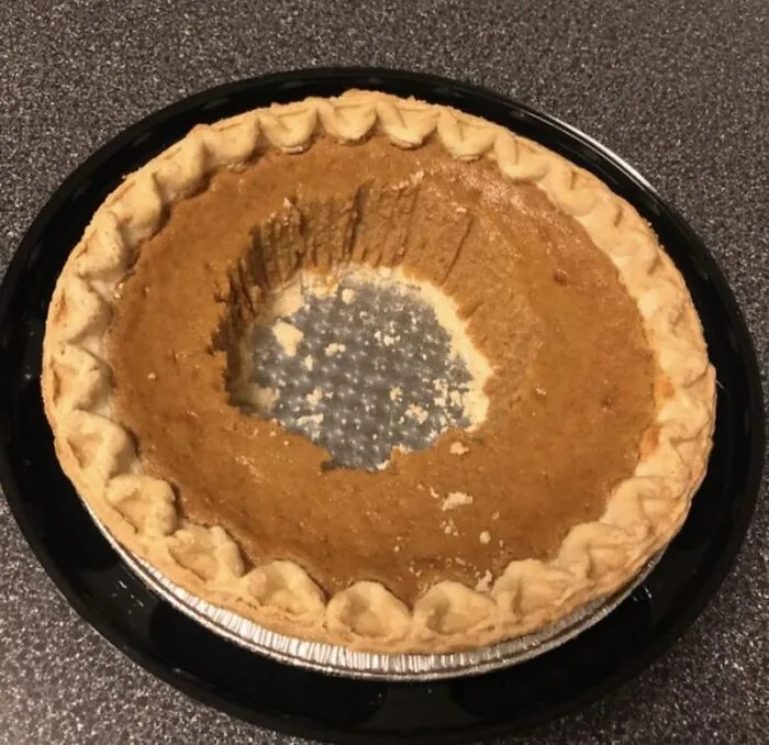 A pumpkin pie eaten directly from the center, showing inconsiderate roommate stories