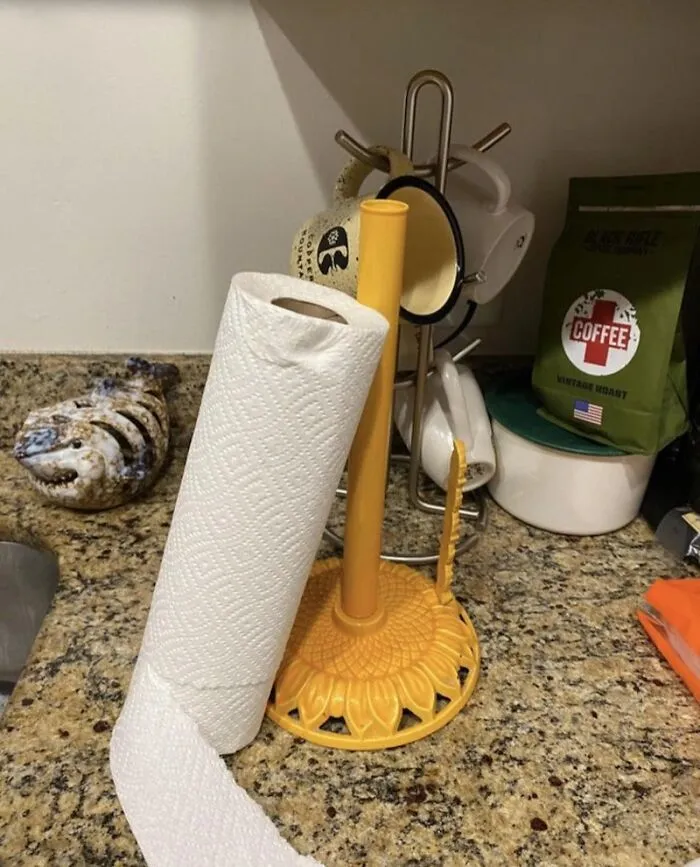A roll of paper towels placed next to its holder instead of on it, showing annoying roommate stories.