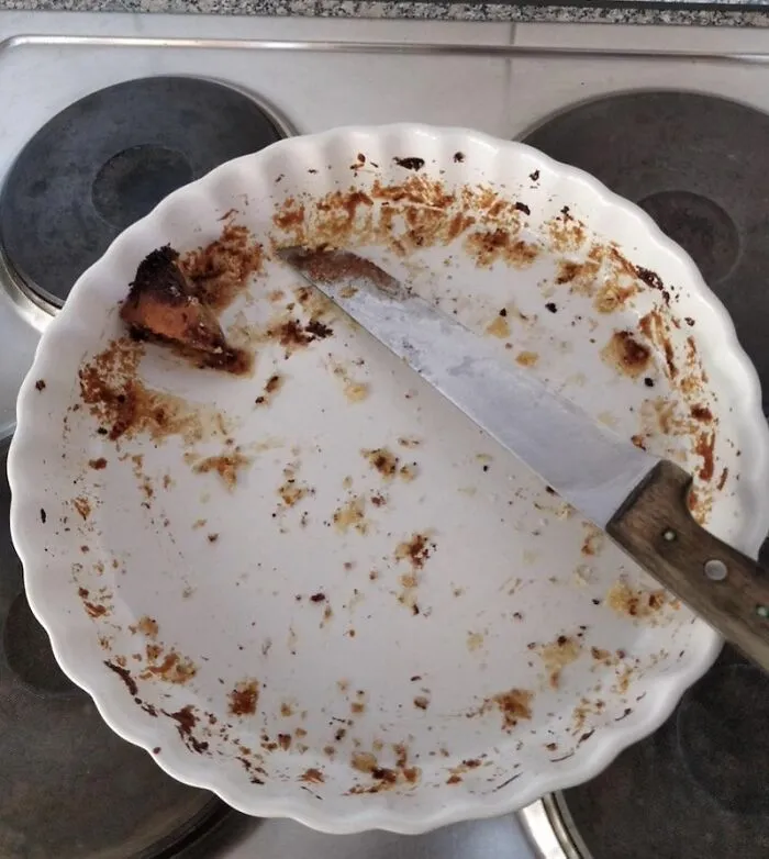 An empty pie dish with just a small crust left, representing inconsiderate roommate stories about food sharing