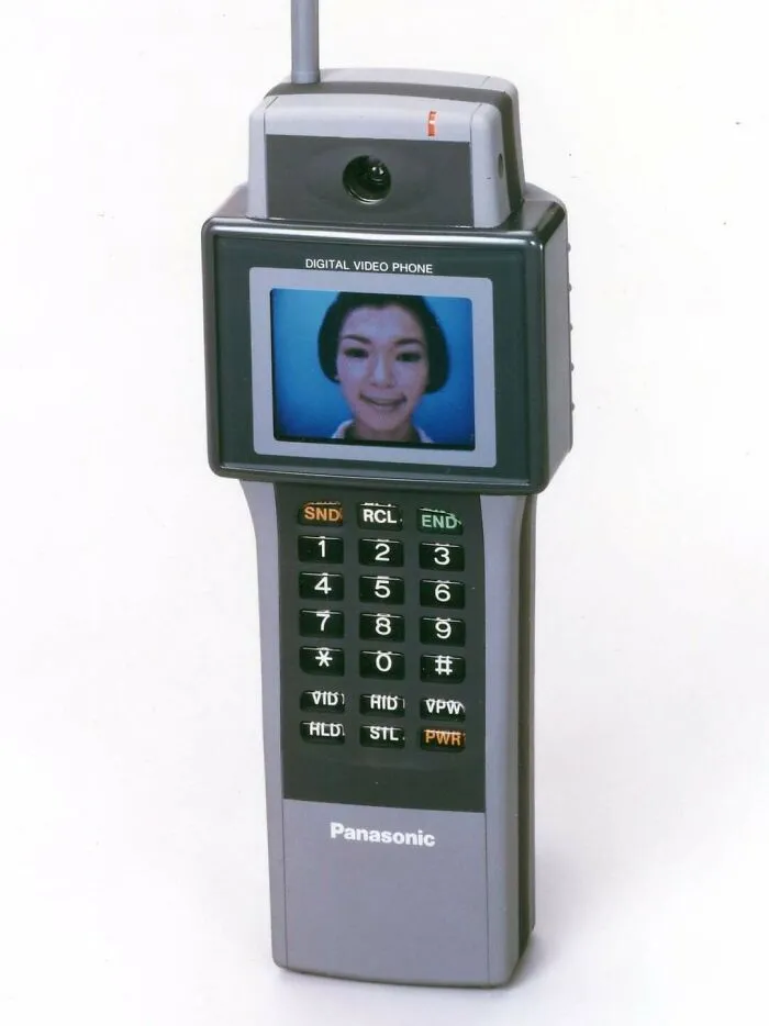 Vintage tech Panasonic digital video phone with antenna showing woman on screen