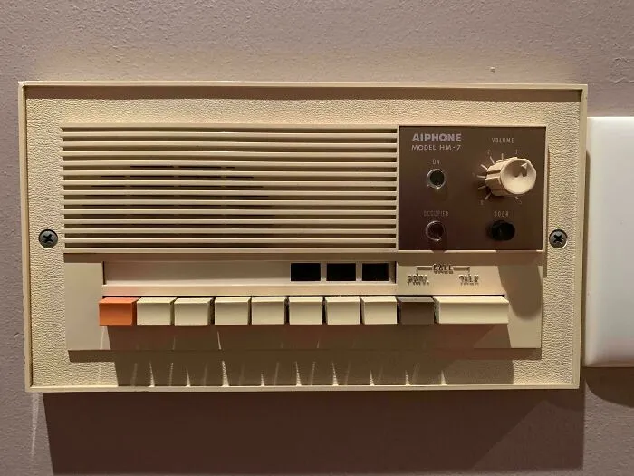 A retro cream-colored wall-mounted intercom system with buttons, demonstrating vintage tech finds