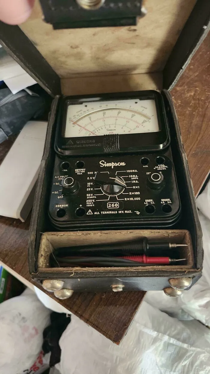 An old-school Simpson analog multimeter in a protective case, representing classic vintage tech equipment