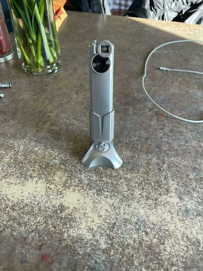 An old silver webcam on a stand, showcasing vintage tech finds