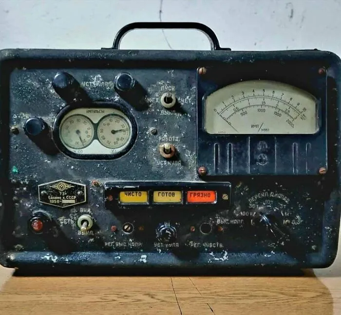 An old-school Soviet vintage tech radiation detector device with physical dials and buttons