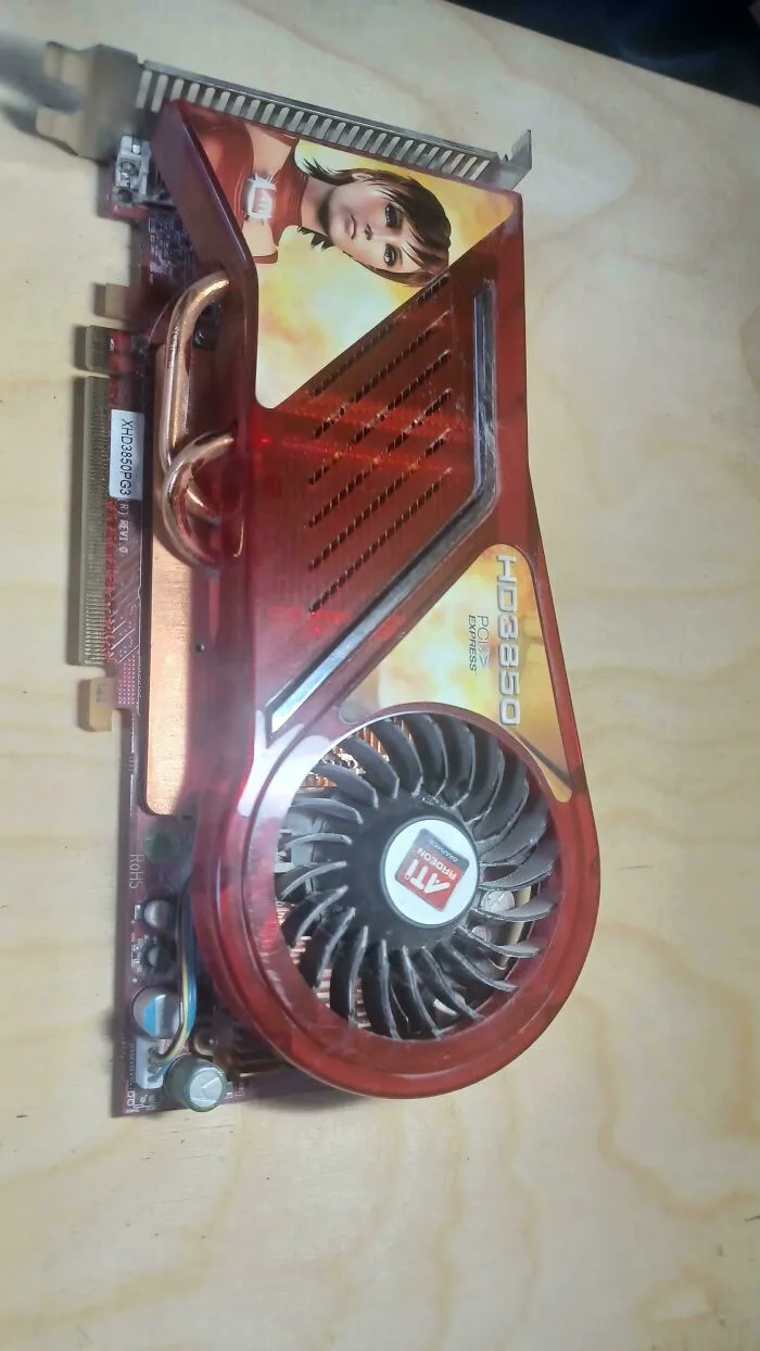 An old ATI Radeon HD 3850 graphics card with a red plastic cover, highlighting vintage tech finds