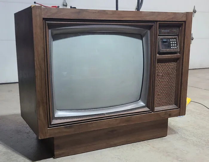 An old-school wooden console television set, a nostalgic item among vintage tech finds
