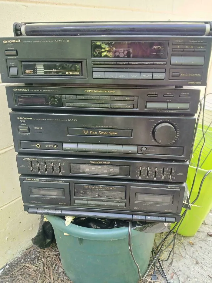 A stacked Pioneer stereo receiver system with cassette players, part of classic vintage tech.