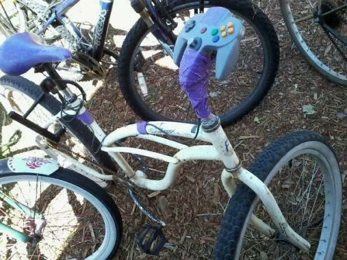 Funny redneck fixes using a video game controller taped to bicycle handlebars as a replacement steering grip.