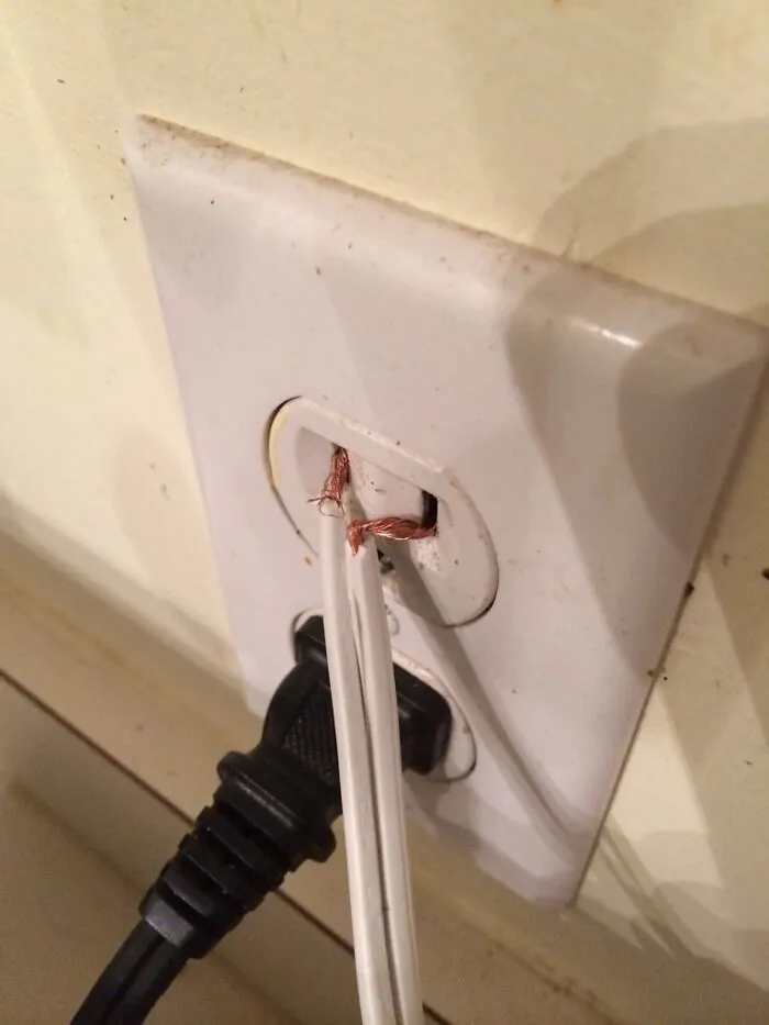 Unsafe electrical wiring in an outlet showing dangerous redneck fixes.