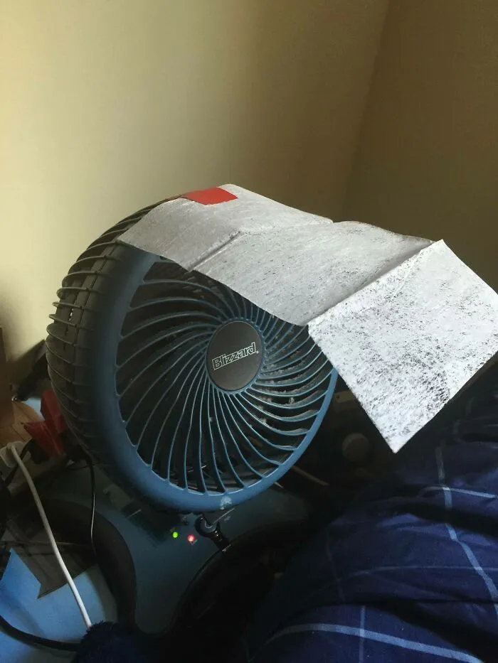 A desk fan with a paper filter taped to the top as simple redneck fixes.