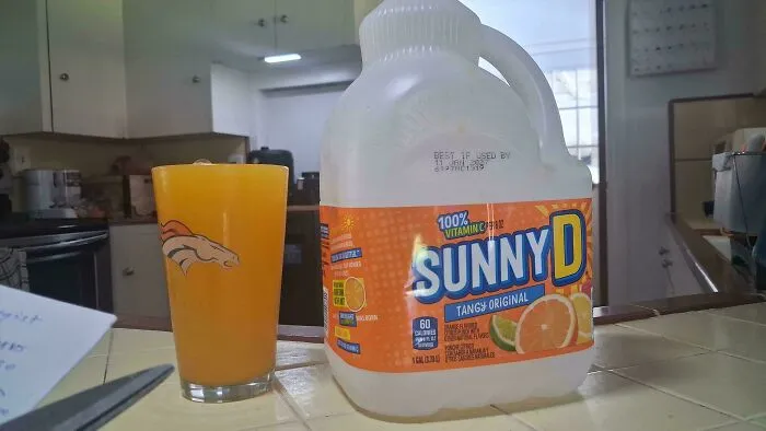 SunnyD bottle and matching orange juice glass, representing satisfying everyday details