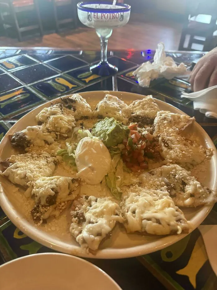 A plate of nachos arranged neatly in a circle with dip, showcasing satisfying and clever ideas.
