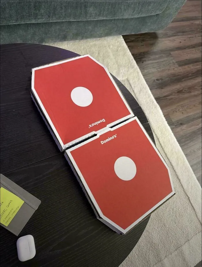 Two Domino pizza boxes arranged side-by-side on a table representing clever ideas of design