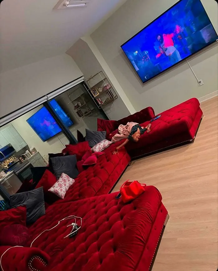 Large red sectional sofa in a spacious living room representing interior design decisions.