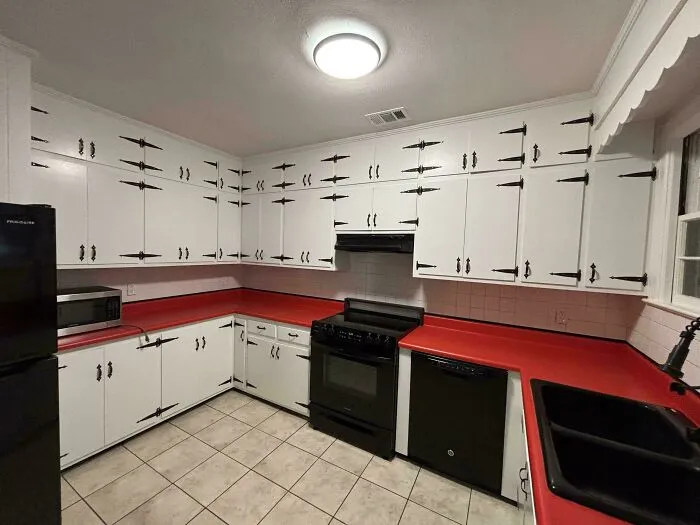 Kitchen packed with excessive dark door hinges highlighting bad interior design decisions
