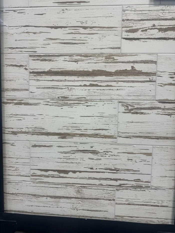 Unfortunate interior design decisions showing faux distressed wood tile backsplash.