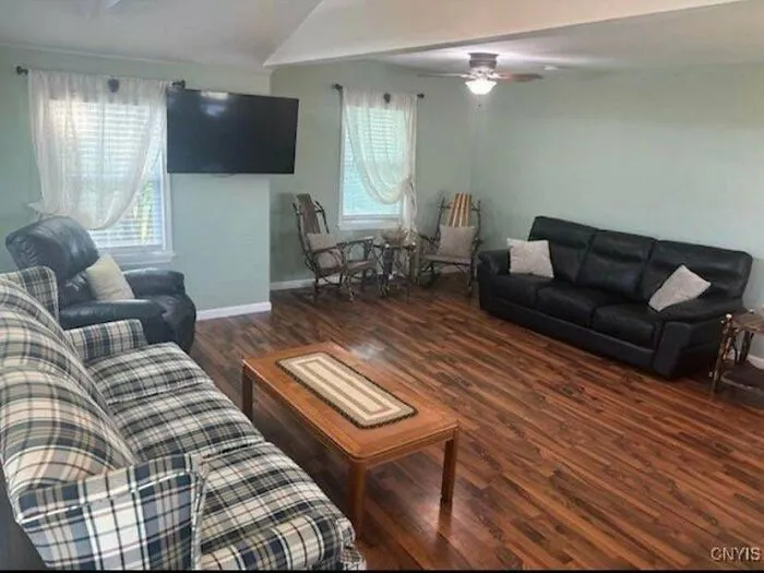 Spacious living room highlighting poor interior design choices with awkward sofa placement and sparse decor