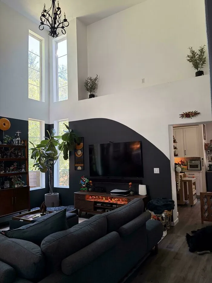 Modern living room featuring an unusual arch wall paint interior design choice.