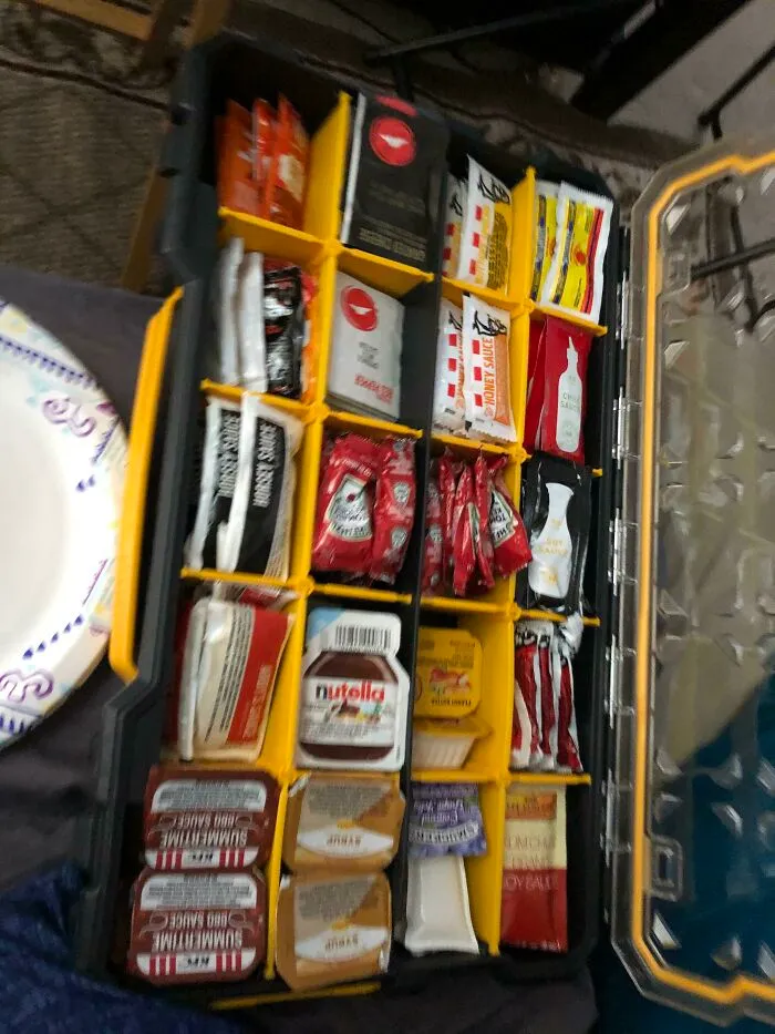 An organized toolbox repurposed to store sauce packets as a clever idea.