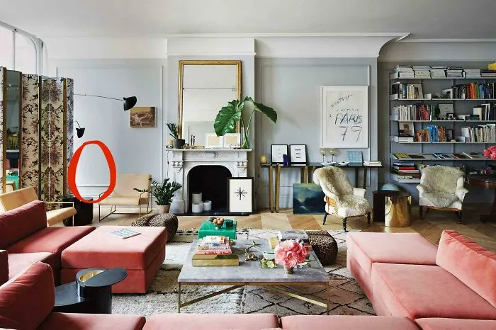 Spacious living room featuring pink velvet sectional sofas and eclectic decor reflecting interior design decisions.