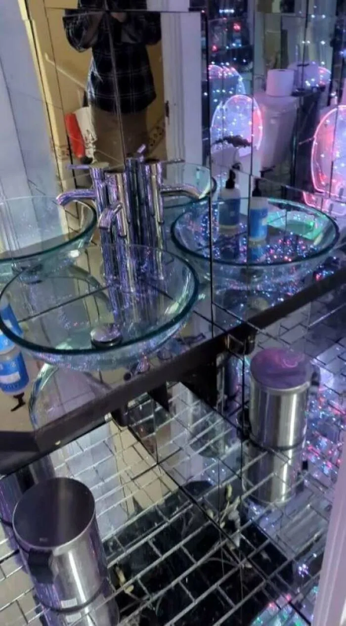 An overwhelming mirrored bathroom vanity setup showcasing an unusual interior design decision.