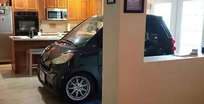 Clever ideas smart car parked inside a home kitchen as an interesting space-saving solution