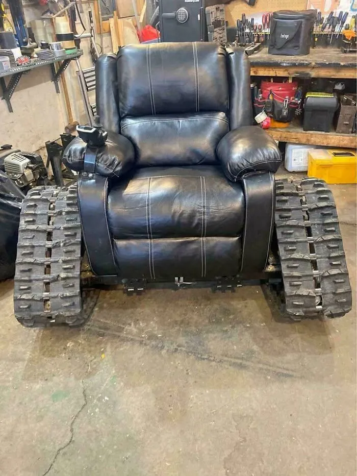 Black leather armchair mounted on heavy-duty tank tracks showcasing redneck fixes.