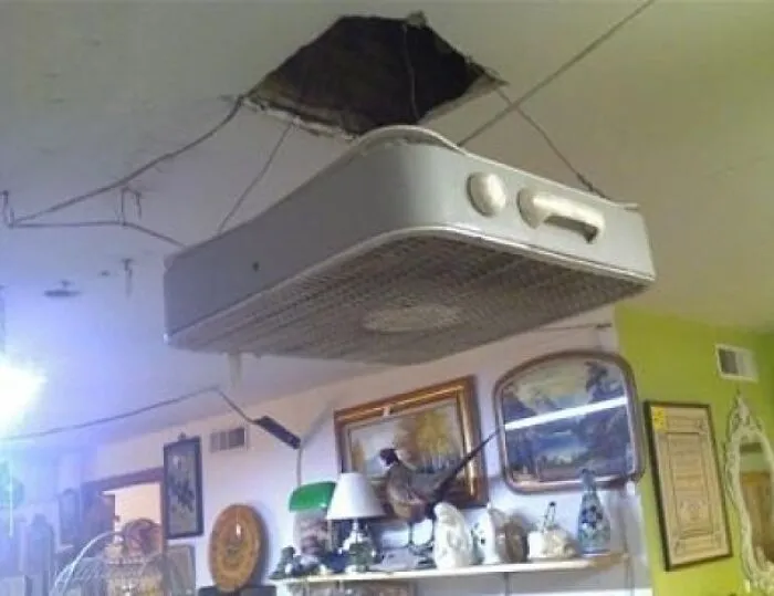 A box fan hanging from the ceiling as an example of redneck fixes.