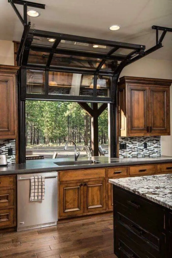 Modern kitchen interior design with a garage door opening to the outdoors.
