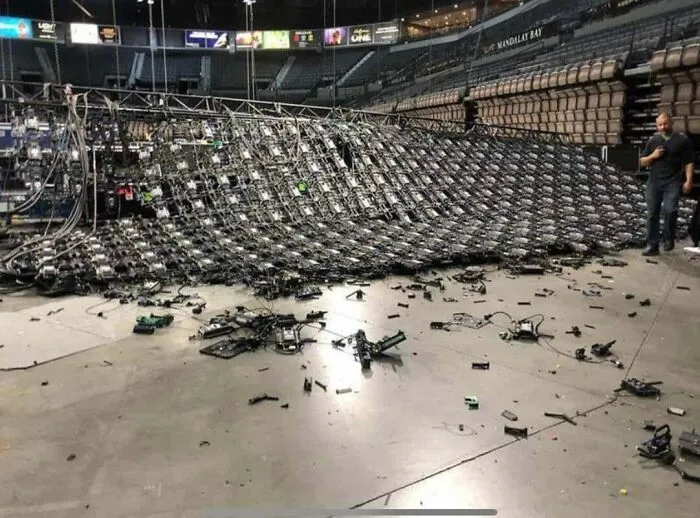A massive stage lighting rig collapsed onto the floor, showing expensive accidents