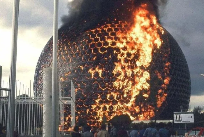 A massive geodesic dome engulfed in bright orange flames, representing expensive accidents