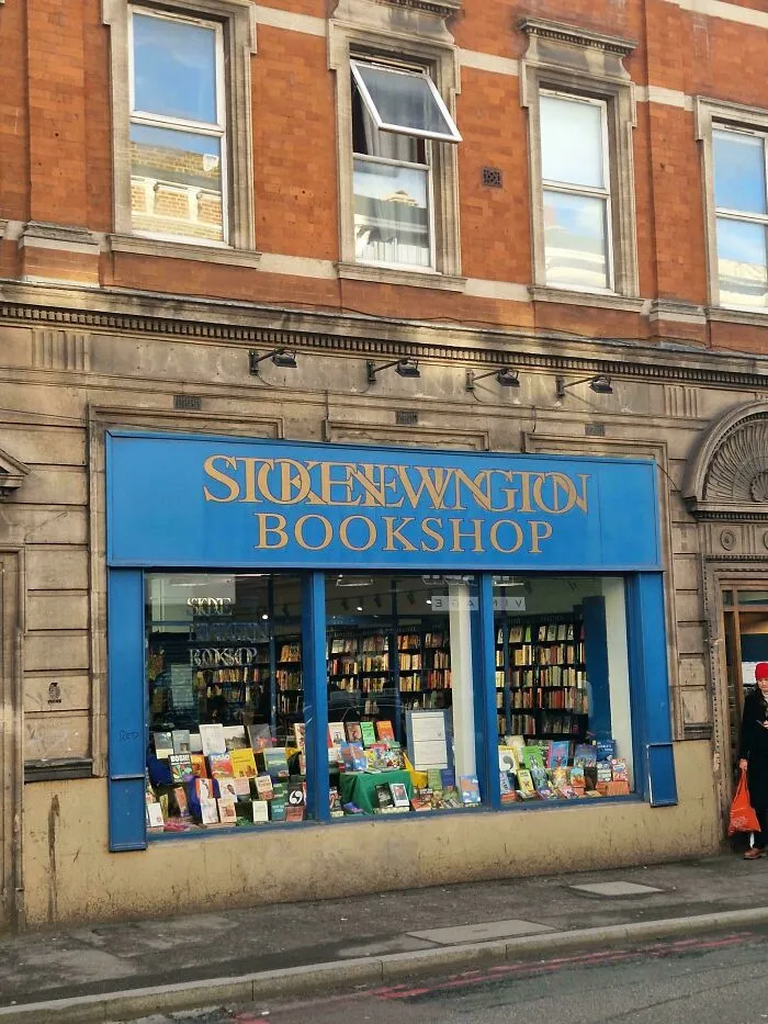 Bookshop storefront with overlapping letters on the blue sign showing typography fails