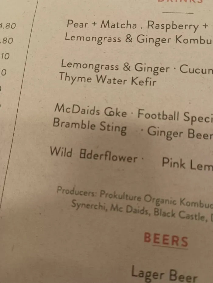 Close-up of a menu with poor letter spacing showing typography fails in Wild Elderflower