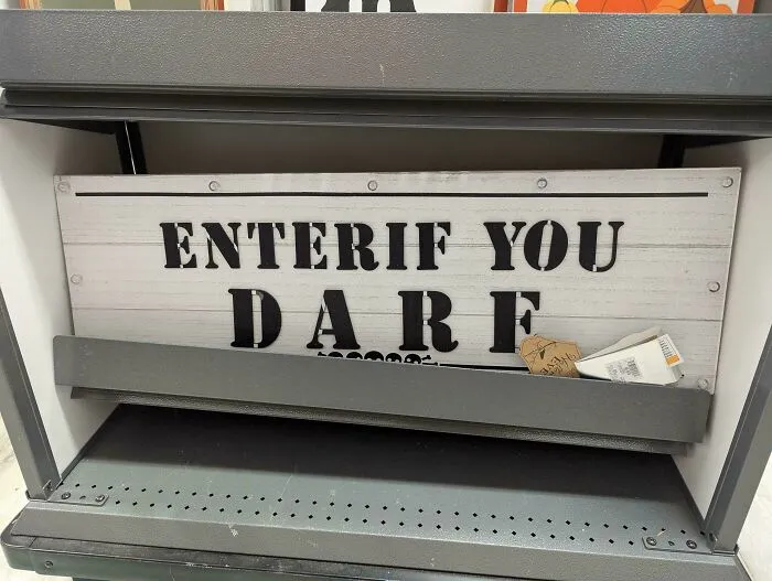 Halloween sign displaying Enter If You Dare with bad letter spacing, showing typography fails