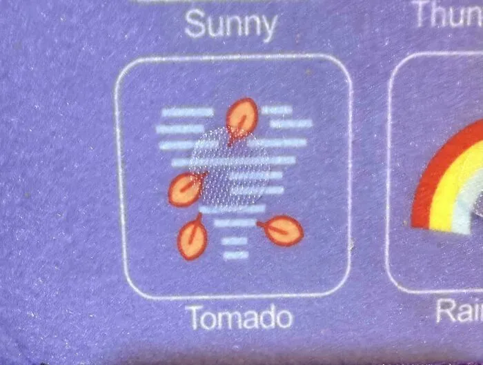 A weather icon on felt fabric misspelled as Tomado due to poor letter spacing