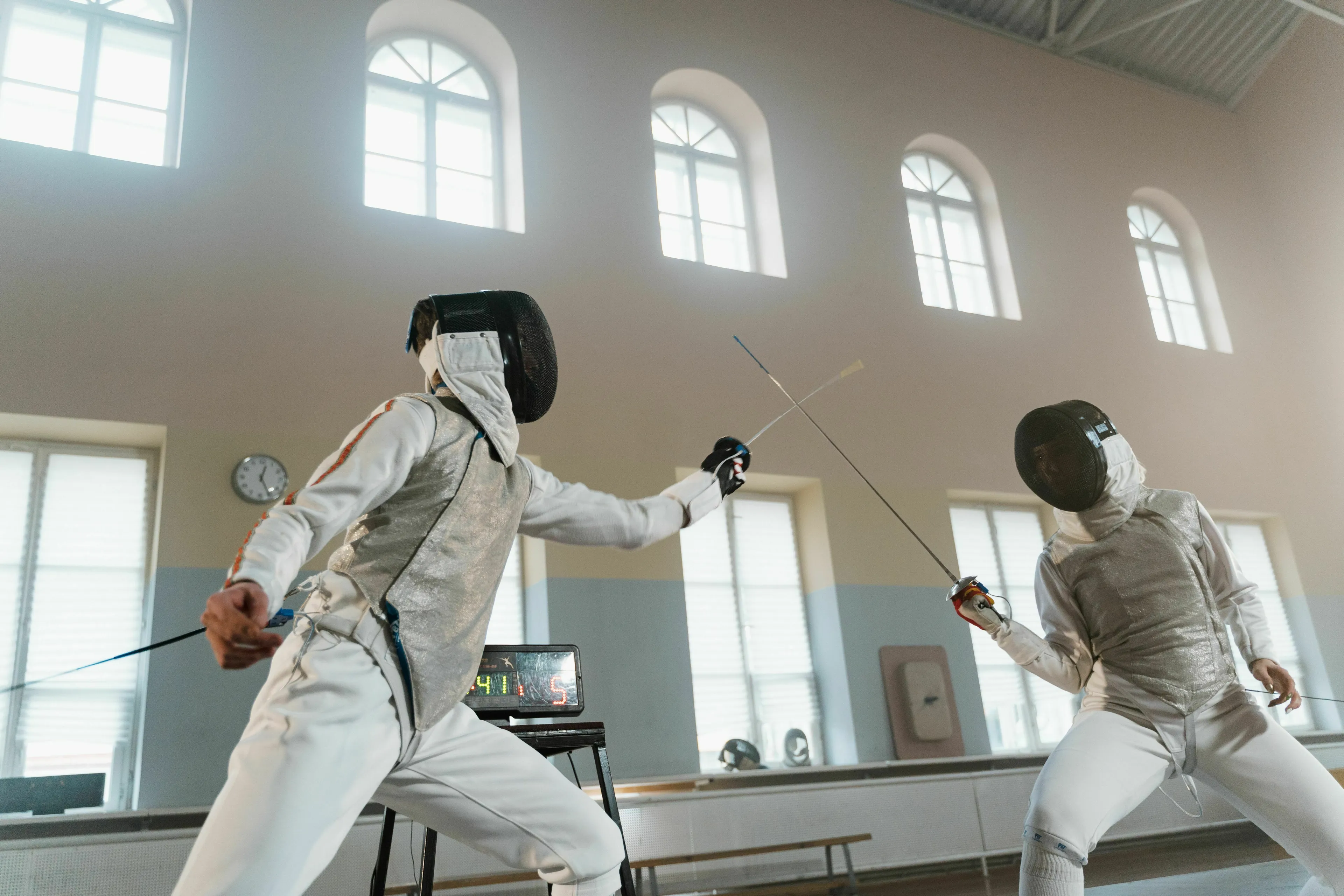Two fencers competing in a match to answer what is this sport called.
