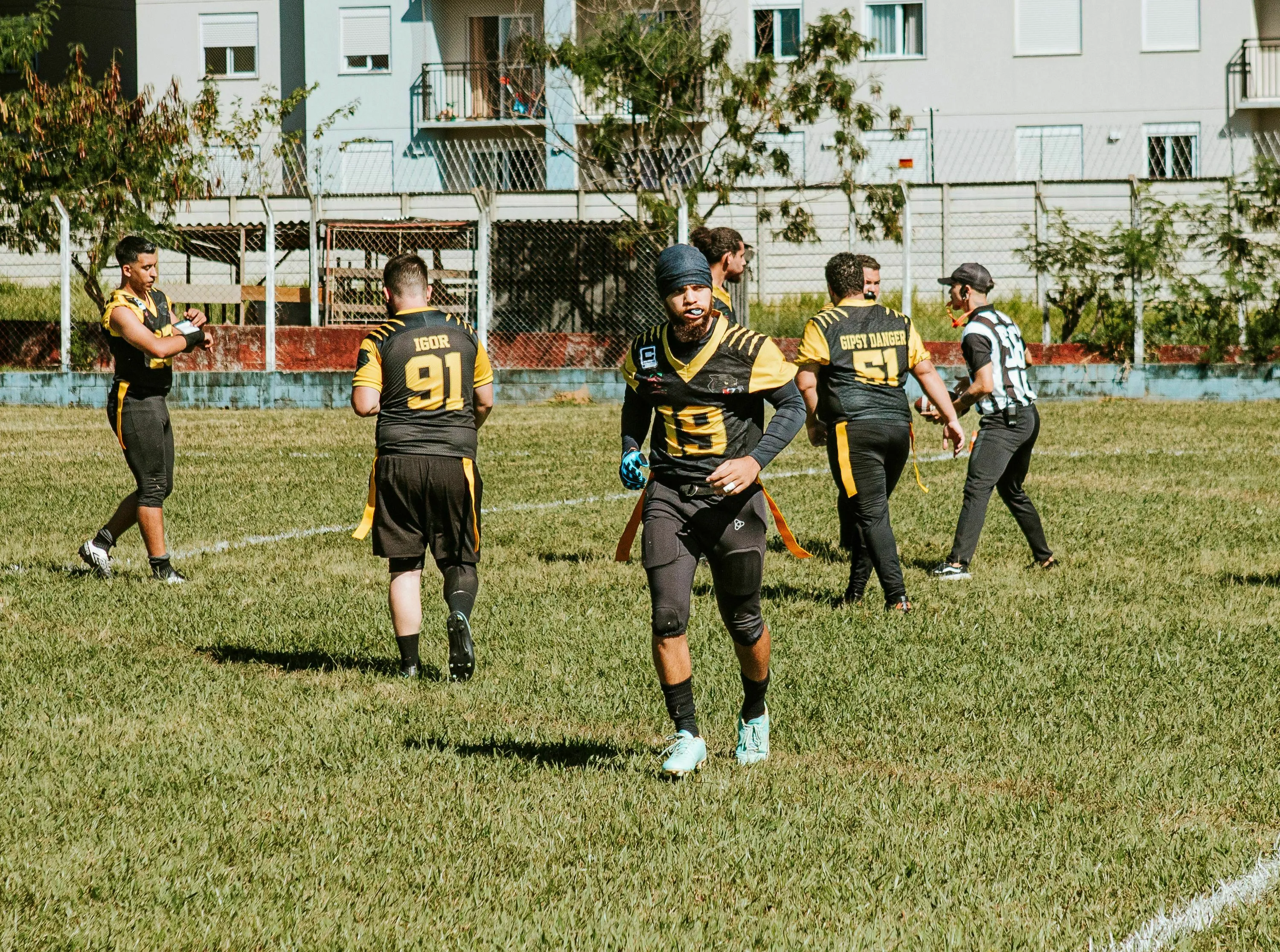 American football players in action during a game on a grassy field.