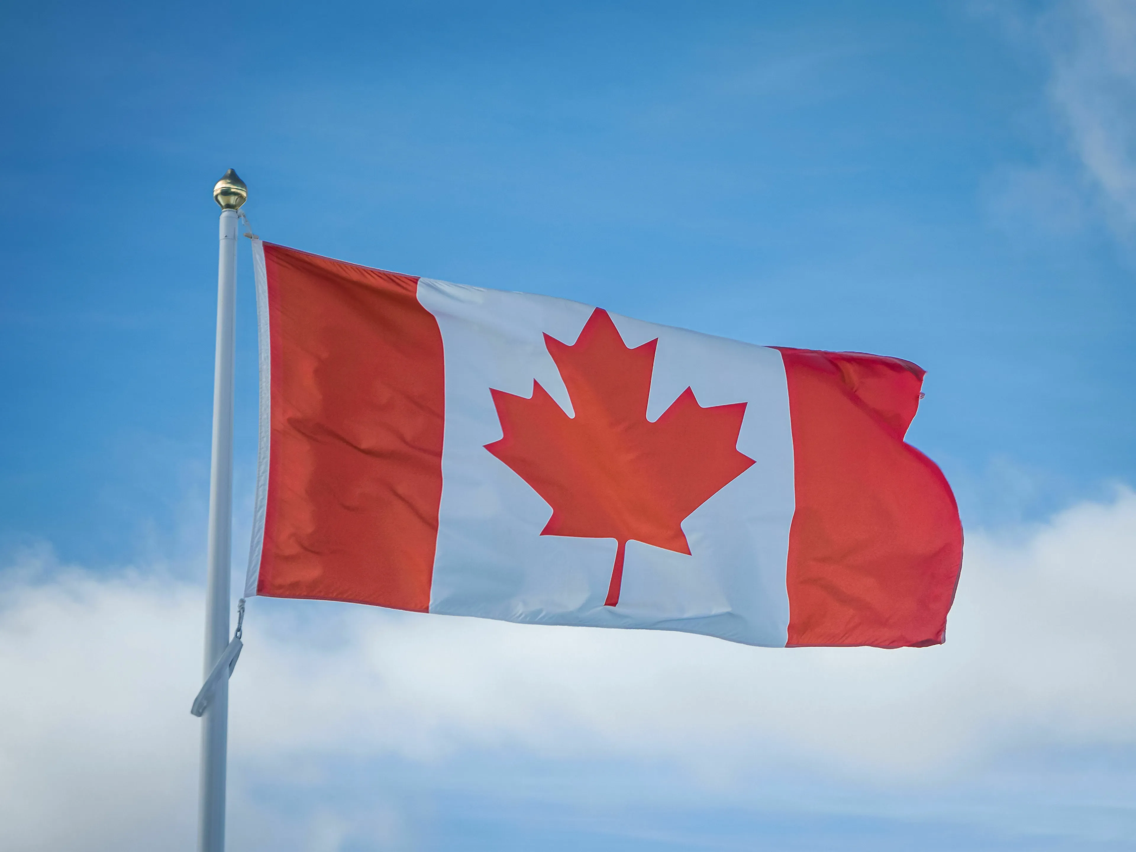 National flag of Canada waving on a pole, featured in a Canada capital city pub quiz question.