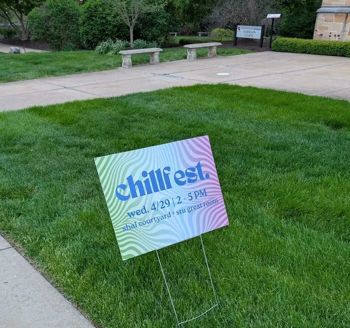 A chillfest yard sign displaying bad letter spacing on a green lawn.