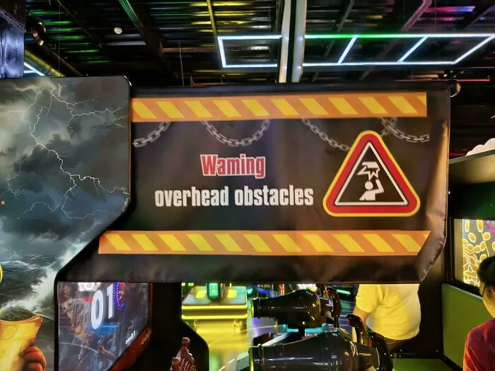 A warning overhead obstacles sign displaying bad letter spacing in the word warning