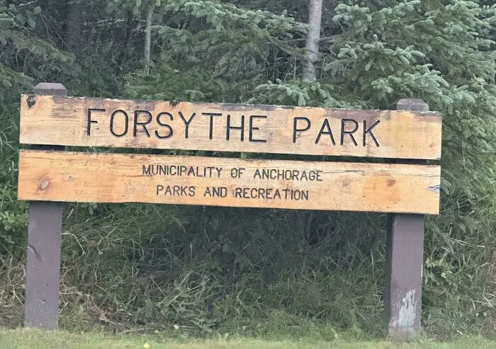 A wooden park sign with a bad letter spacing design fail reading FORSYTHE PARK.