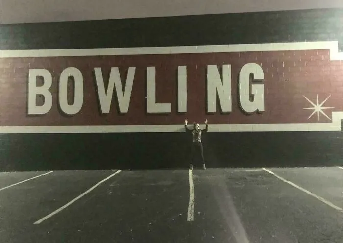 Large building wall displaying a classic typography fail with uneven letter spacing on the word BOWLING.