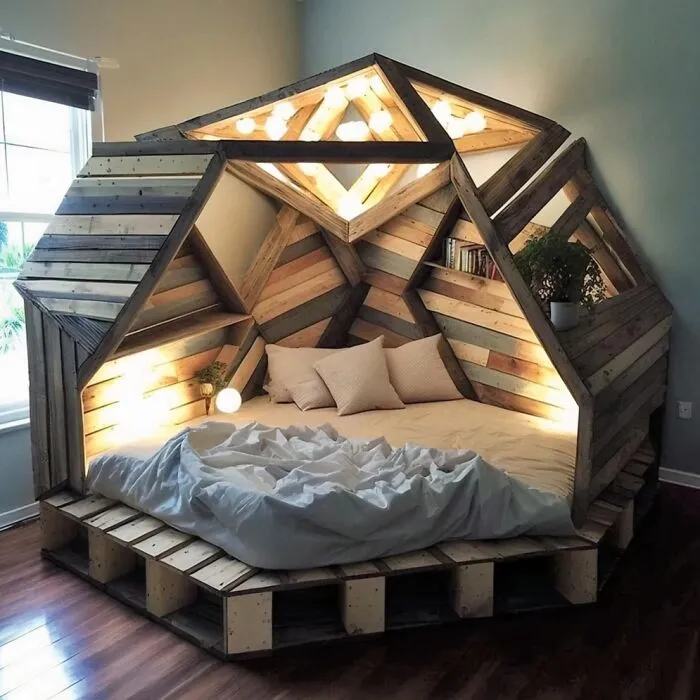 A cozy dome-shaped bed built from geometric wood panels and warm lighting as one of many clever wooden creations
