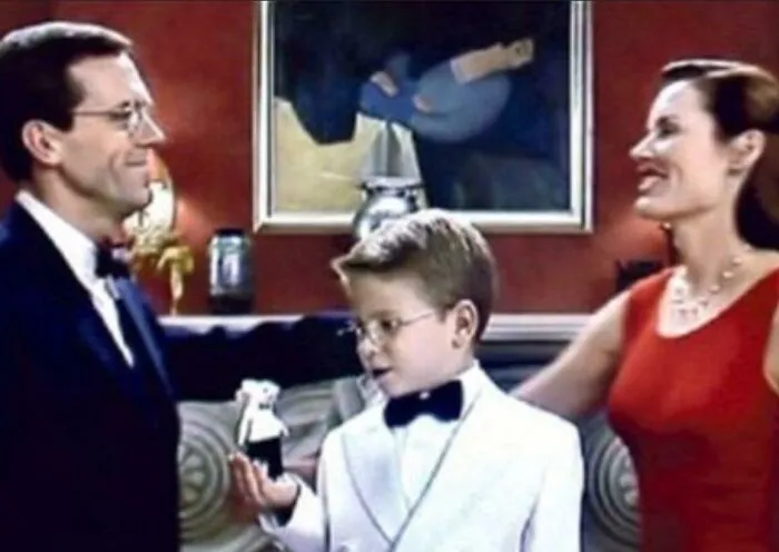 A scene from Stuart Little featuring the family looking at the mouse, classic movie props.