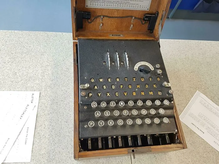 An antique German Enigma machine in a wooden box, a fascinating piece of historical movie props.