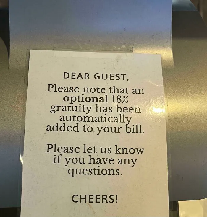 A restaurant sign stating an optional 18% gratuity is automatically added, showing questionable decisions.