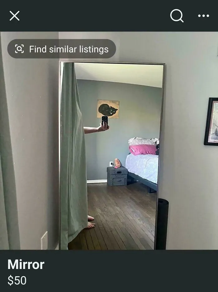 Humorous mirror pic reflection showing a person hiding behind a curtain while holding a phone