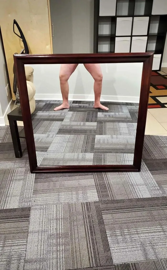 Funny mirror pics showing a reflection of bare legs standing behind a framed mirror on sale.