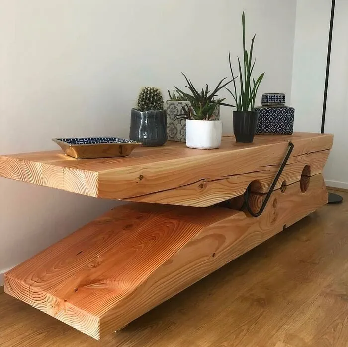 A giant clothespin coffee table displaying unique wooden creations in a living room